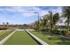Outdoor bocce court with lush landscaping, seating, and a scenic view of the surrounding area at 29924 Rusco Ct, Wesley Chapel, FL 33545