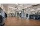 Large gym featuring wood floors, mirrors, ceiling fans and open space for exercise and fitness activities at 29924 Rusco Ct, Wesley Chapel, FL 33545