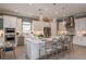 Bright, open kitchen featuring a central island with seating and stainless steel appliances at 29924 Rusco Ct, Wesley Chapel, FL 33545