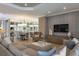 Open-concept living and dining area featuring contemporary decor and large wall mirrors at 29924 Rusco Ct, Wesley Chapel, FL 33545