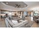 Open-concept living room flowing into the kitchen, featuring a modern ceiling fan at 29924 Rusco Ct, Wesley Chapel, FL 33545