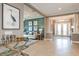 Open-concept living room with stylish decor and view of entry hall with double doors at 29924 Rusco Ct, Wesley Chapel, FL 33545