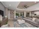 Bright living room featuring an oversized sectional sofa, and sliding glass doors to a private pool at 29924 Rusco Ct, Wesley Chapel, FL 33545