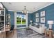 Cozy living room with paneled walls, a large window, and a comfortable sofa at 29924 Rusco Ct, Wesley Chapel, FL 33545
