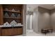 Modern locker room with towel service, a wooden bench, and access to showers at 29924 Rusco Ct, Wesley Chapel, FL 33545