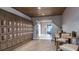 Elegant wine storage area with wooden lockers, tiled floors, and a cozy seating area at 29924 Rusco Ct, Wesley Chapel, FL 33545