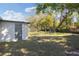 The backyard of this home features mature trees, and a shed-like structure at 306 Midwood Dr, Plant City, FL 33566