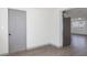 Bright hallway with gray door and luxury vinyl plank flooring at 306 Midwood Dr, Plant City, FL 33566