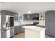 Stylish kitchen with gray cabinetry, stainless steel appliances, and island at 306 Midwood Dr, Plant City, FL 33566