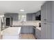 Modern kitchen featuring grey cabinets, white countertops, and stainless steel appliances at 306 Midwood Dr, Plant City, FL 33566