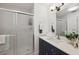 Bathroom featuring glass shower door, vanity with storage, neutral color and a mirror at 3092 Osprey Ln, Clearwater, FL 33762