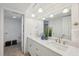 Bright bathroom with double vanity, marble countertop, pendant lighting and neutral finishes at 3092 Osprey Ln, Clearwater, FL 33762