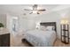 Cozy bedroom with light wood floors, ceiling fan, and closet at 3092 Osprey Ln, Clearwater, FL 33762