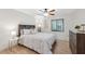 Cozy bedroom with light wood floors, ceiling fan, and natural light from the window at 3092 Osprey Ln, Clearwater, FL 33762