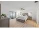 Bedroom featuring light wood floors, neutral walls, minimalist decor, and a large window at 3092 Osprey Ln, Clearwater, FL 33762