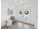 Bright foyer with tiled floors, white walls, decorative double doors and a cozy bench at 3092 Osprey Ln, Clearwater, FL 33762
