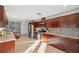 Modern kitchen with wood cabinets, stainless appliances, granite countertops, and mosaic backsplash at 3092 Osprey Ln, Clearwater, FL 33762