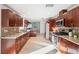 Beautiful kitchen with rich wood cabinets, stainless steel appliances, granite countertops, and tile backsplash at 3092 Osprey Ln, Clearwater, FL 33762