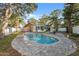Enjoy this kidney-shaped pool with brick pavers surrounded by shady trees in a private backyard at 3092 Osprey Ln, Clearwater, FL 33762