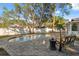 Relax by the kidney-shaped pool on the brick paver patio with a lovely seating arrangement at 3092 Osprey Ln, Clearwater, FL 33762