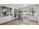 Sunroom featuring tile flooring, a hanging chair, and ample natural light at 3092 Osprey Ln, Clearwater, FL 33762