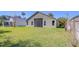 Well-maintained backyard with a spacious detached garage or shed and ample green space at 3133 Beaver Pond Trl, Valrico, FL 33596