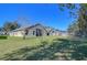 Expansive backyard featuring a lush lawn and mature trees for shade and privacy at 3133 Beaver Pond Trl, Valrico, FL 33596