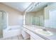 Bright bathroom features a double sink vanity, glass shower, and tiled floors at 3133 Beaver Pond Trl, Valrico, FL 33596