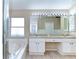 Bright bathroom features a double sink vanity, glass shower, and tiled floors at 3133 Beaver Pond Trl, Valrico, FL 33596