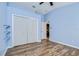 Bedroom featuring wood-look floors and a closet at 3133 Beaver Pond Trl, Valrico, FL 33596