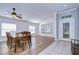 A spacious dining room featuring wood floors, a decorative ceiling, and a light blue wall at 3133 Beaver Pond Trl, Valrico, FL 33596