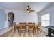 A well-lit dining area with a decorative ceiling, a wooden dining table, and wood-look flooring at 3133 Beaver Pond Trl, Valrico, FL 33596