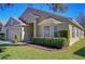 A single-story home featuring manicured landscaping, green grass, and large windows at 3133 Beaver Pond Trl, Valrico, FL 33596