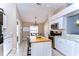 Charming eat-in kitchen with white cabinets, an island, and stainless steel appliances at 3133 Beaver Pond Trl, Valrico, FL 33596