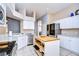 Well-equipped kitchen with stainless steel appliances, white cabinets, and a butcher block island at 3133 Beaver Pond Trl, Valrico, FL 33596