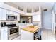 Bright kitchen featuring white cabinets, stainless steel appliances, and a butcher block island at 3133 Beaver Pond Trl, Valrico, FL 33596