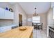 Bright kitchen with stainless steel appliances, a kitchen island, and neutral-colored walls at 3133 Beaver Pond Trl, Valrico, FL 33596