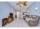 Bright living room featuring tile floors, a ceiling fan, and an open floor plan at 3133 Beaver Pond Trl, Valrico, FL 33596
