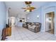Open living space with tile flooring, comfortable seating, and access to other rooms at 3133 Beaver Pond Trl, Valrico, FL 33596