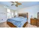 This room has vaulted ceilings, hardwood floors, and a large bedroom set with private bathroom at 3133 Beaver Pond Trl, Valrico, FL 33596