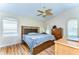 Large main bedroom with hardwood floors, fan, and plenty of natural light at 3133 Beaver Pond Trl, Valrico, FL 33596