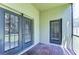 A quaint, screened in patio with brick floors and doors leading into the home at 3133 Beaver Pond Trl, Valrico, FL 33596