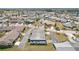 High aerial view shows a clean, single-story home in a mature neighborhood, with a view of a pond at 334 Club Manor Dr, Sun City Center, FL 33573