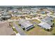 An aerial view showcases a house with a mature lawn located in a lovely community with a nearby pond and golf course at 334 Club Manor Dr, Sun City Center, FL 33573