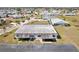 Aerial view of the home showcasing the roof, screened lanai, landscaping, and neighborhood at 334 Club Manor Dr, Sun City Center, FL 33573