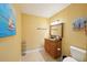 Bathroom with a single vanity, granite countertop, tile floors and beach-themed decorations at 334 Club Manor Dr, Sun City Center, FL 33573