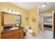 Bathroom featuring granite countertop, tile floors, shower and beach-themed decorations at 334 Club Manor Dr, Sun City Center, FL 33573