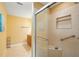 Bright bathroom features tile floors, glass enclosed shower with grab bars, and a granite vanity at 334 Club Manor Dr, Sun City Center, FL 33573