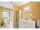 Bright bathroom featuring a vanity with storage, tile floors, and a tub with shower at 334 Club Manor Dr, Sun City Center, FL 33573