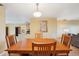 A dining room with a wooden table and hardwood floors adjoins a living room and kitchen at 334 Club Manor Dr, Sun City Center, FL 33573